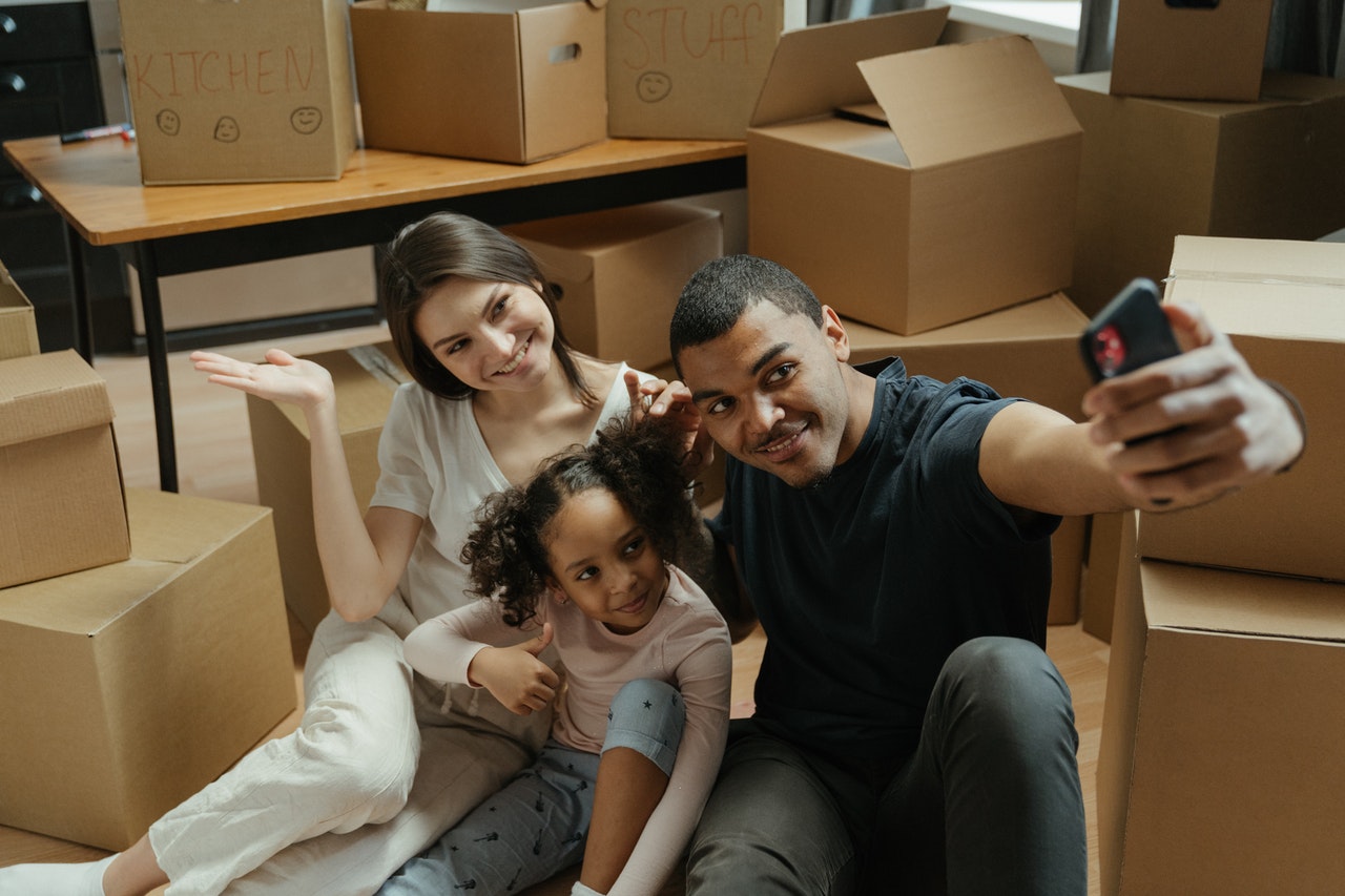 family surrounded by moving boxes