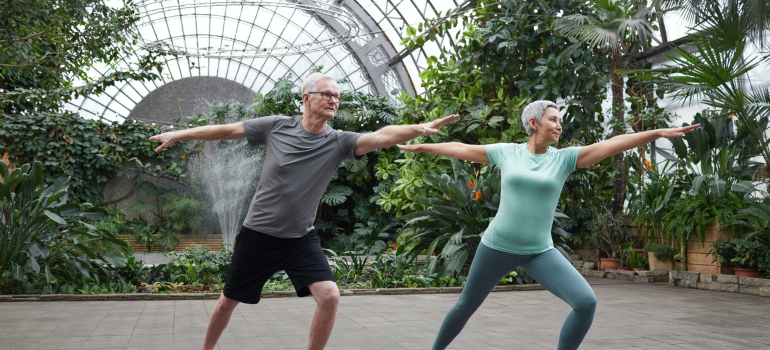 elderly couple doing yoga