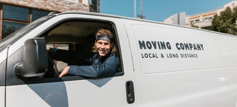 a person driving a moving van representing hiring a moving crew to combine two households without stress