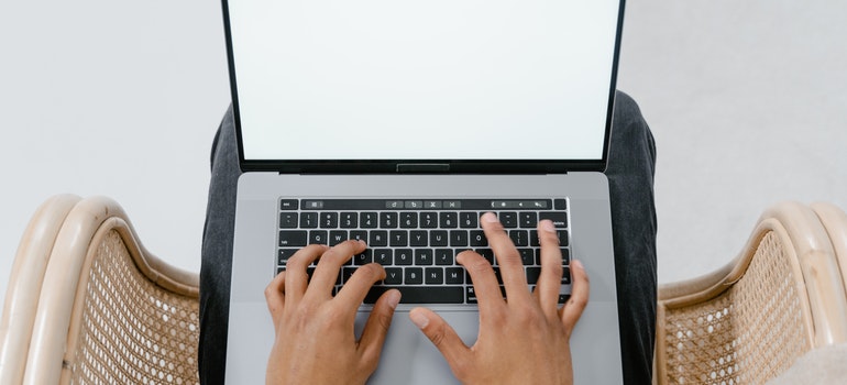 A person typing on a laptop