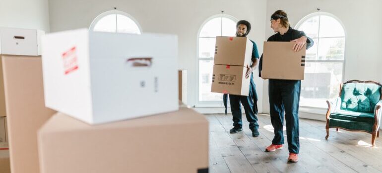 Professional movers carrying boxes