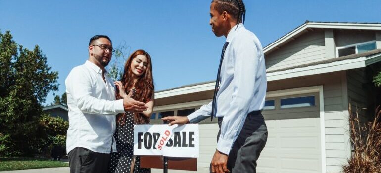 A couple buying a house from real estate agent
