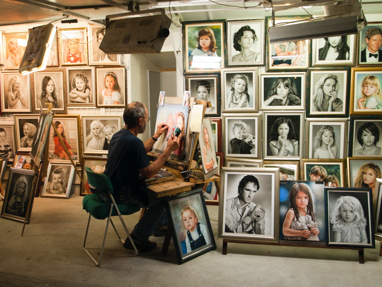 A man painting in his gallery