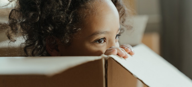 A girl in a cardboard box