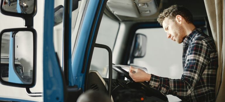 a person reading papers inside a vehicle