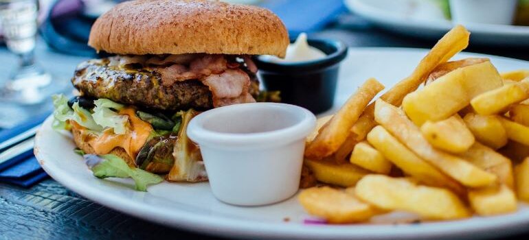 A burger with fries on a plate.