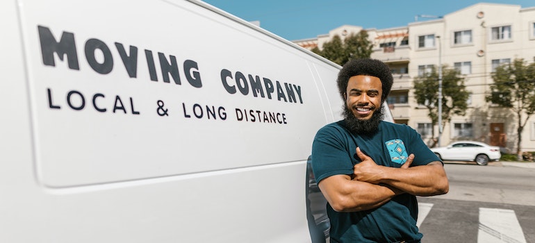 Man standing next to a moving van