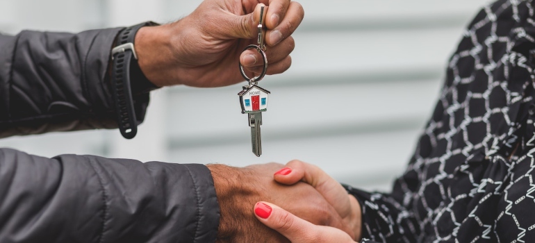 a person handling the home keys